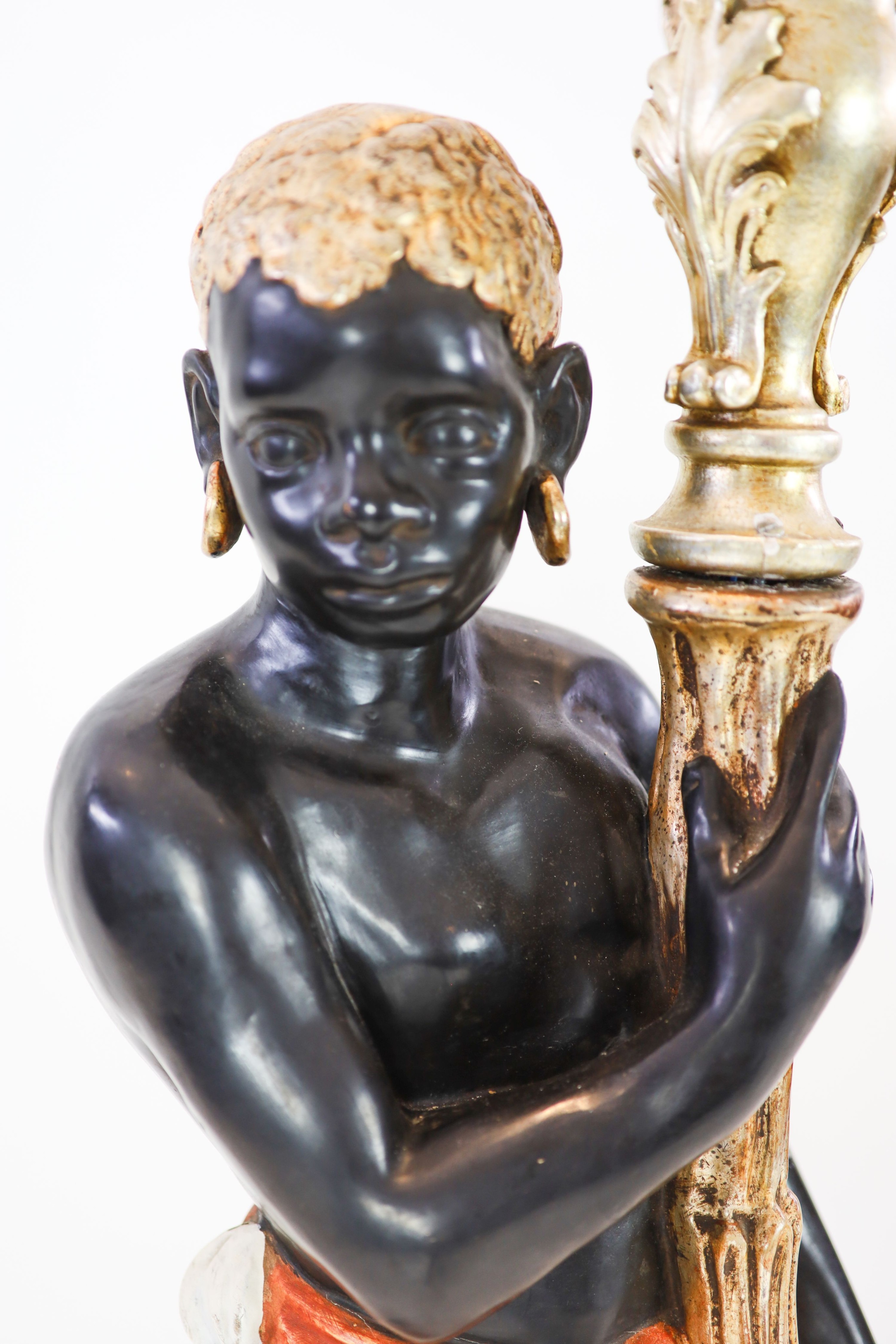 An 18th century style Venetian design polychrome painted carved wood blackamoor figure, poised as a six light candelabrum, height 169cm
